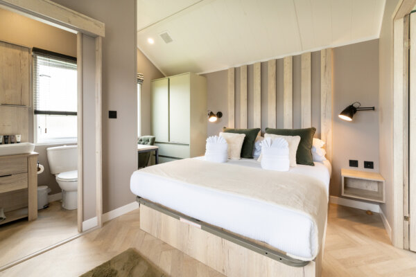 King sized bed with wooden panelling at the top