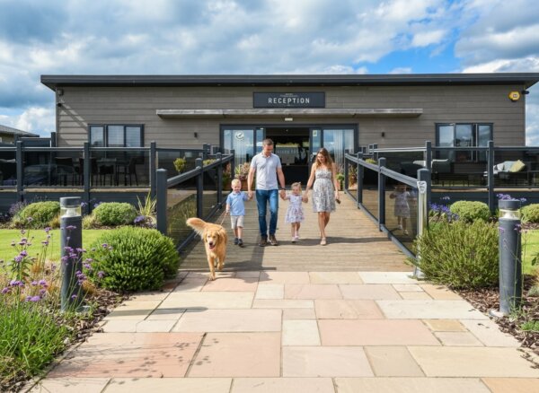Young family with dog walking from reception Ullswater
